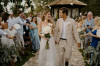 Newly weds leaving the ceremony area, showered in confetti